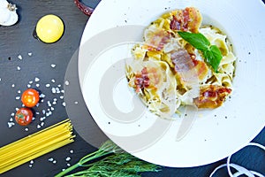 Pasta Carbonara. Spaghetti with bacon and parmesan cheese on dark background