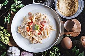 Pasta Carbonara in white dish, surround fresh ingredient