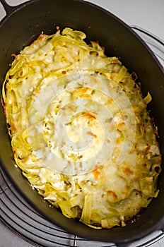 Pasta with cheese and butter in castiron pot photo
