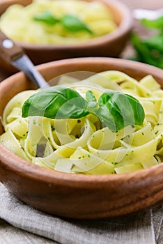 Pasta with chicken and vegetables on wooden background