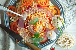 Pasta in a composition with accessories on the table, on an old background.