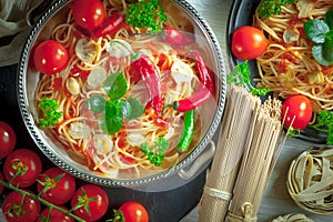 Pasta in a composition with accessories on the table, on an old background.