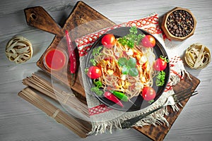 Pasta in a composition with accessories on the table, on an old background.