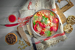 Pasta in a composition with accessories on the table, on an old background.