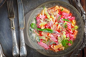 Pasta in a composition with accessories on the table, on an old background.