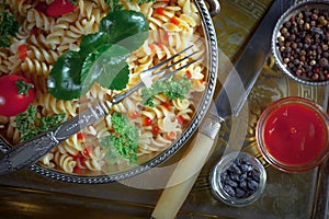 Pasta in a composition with accessories on the table, on an old background.