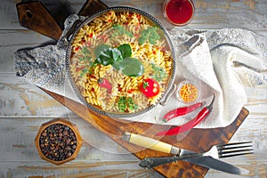 Pasta in a composition with accessories on the table, on an old background.