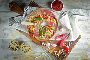 Pasta in a composition with accessories on the table, on an old background.