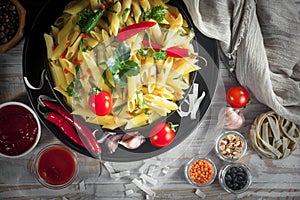 Pasta in a composition with accessories on the table, on an old background.