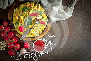 Pasta in a composition with accessories on the table, on an old background.