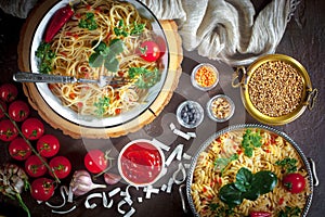 Pasta in a composition with accessories on the table, on an old background.