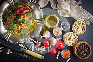 Pasta in a composition with accessories on the table, on an old background.