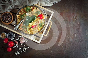 Pasta in a composition with accessories on the table, on an old background.