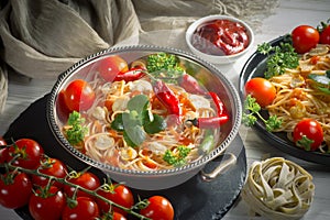 Pasta in a composition with accessories on the table, on an old background.