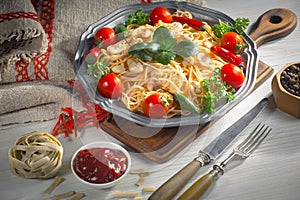 Pasta in a composition with accessories on the table, on an old background.