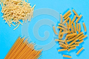 Pasta concent. Differernt types of pasta on blue background. Creative layout pasta guide concept. Top view or flat lay