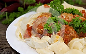 Pasta Conchiglie and meatballs with tomato sauce on rustic wooden background. Soft focus