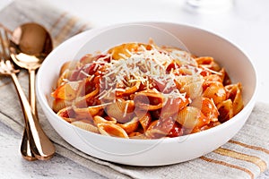 Pasta conchiglie with tomato sauce and parmesan cheese