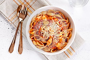 Pasta conchiglie with tomato sauce and parmesan cheese