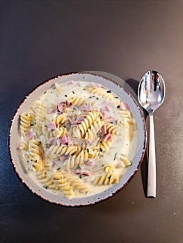 Pasta with cooked ham in cream sauce