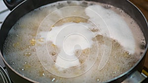 pasta is cooked in a pan, close up top view