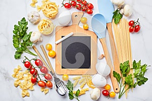 Pasta cooking background with chalkboard, tomatoes, herbs, mushrooms, eggs, top view. Italian cuisine concept