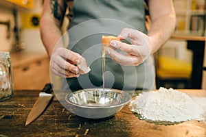 Pasta cooking process, male chef hands with egg