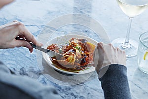 pasta dish lobster stuffed ravioli and glass of pairing wine in close up, food photography