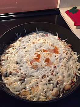 A pasta dish sitting on a stove top