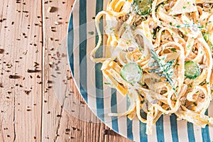 Pasta dish with a sour cream and herbs on wooden boards