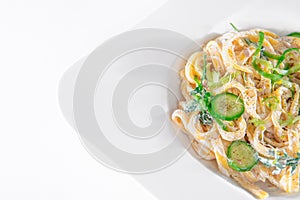 Pasta dish with a sour cream and herbs on wooden boards