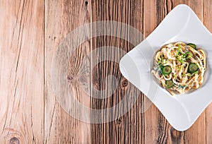 Pasta dish with a sour cream and herbs on wooden boards