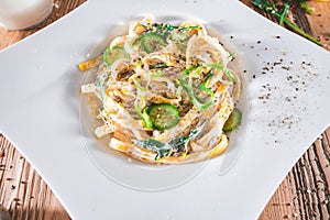 Pasta dish with a sour cream and herbs on wooden boards