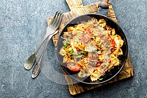 Pasta farfalle with roasted meat and tomatoes