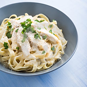 Pasta fettuccine alfredo with chicken, parmesan and parsley