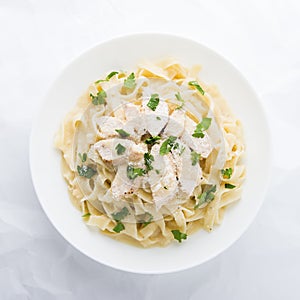 Pasta fettuccine alfredo with chicken, parmesan and parsley