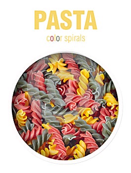 Pasta in the form of a spiral of different colors, located behind a round hole with shadows from it, are isolated on a