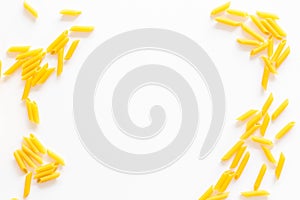 Pasta frame. Uncooked penne on white background top view copy space