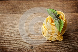 Pasta fresh basil on wood