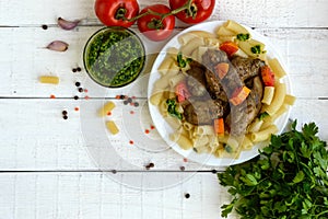 Pasta and fried goose liver (chicken, duck) with pesto and tomat