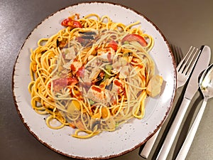 Pasta with fried meat, vegetables and chilli sauce