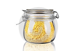 Pasta in a glass jar on a white background isolated