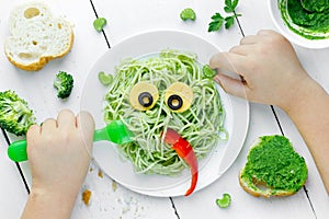 Pasta with green vegetables pesto shaped cute monster - healthy