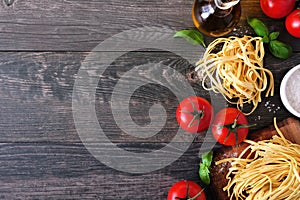 Pasta ingredients, above view corner border against a wooden background