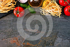 Pasta ingredients, above view top border against a slate background