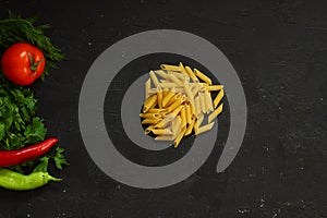 Pasta ingredients on black table  italian cuisine concept