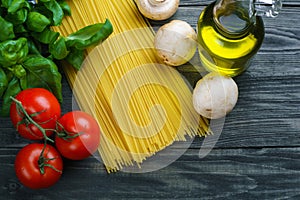 Pasta ingredients. Raw spaghetti, tomatoes, basil, olive oil, mu