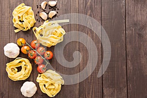 Pasta ingredients. tomato, garlic and pepper on wooden background