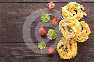 Pasta ingredients. tomato on the wooden background