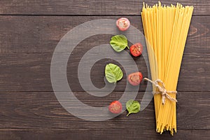 Pasta ingredients. tomato on the wooden background